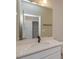 Well-lit bathroom features a granite countertop, dark faucet, and an open view to the closet at 16434 Hamlin Hills Rd, Winter Garden, FL 34787