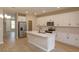 Modern kitchen featuring white cabinets, stainless steel appliances, and a center island with sink at 16434 Hamlin Hills Rd, Winter Garden, FL 34787