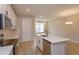 Modern kitchen featuring white cabinets, stainless steel appliances, and an island with a sink at 16434 Hamlin Hills Rd, Winter Garden, FL 34787