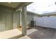 Paver patio and porch with a white fence and side entry door at 16434 Hamlin Hills Rd, Winter Garden, FL 34787