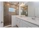 Modern bathroom featuring a double sink vanity, tiled shower with glass door, and contemporary fixtures at 16465 Hamlin View St, Winter Garden, FL 34787