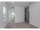 Bright hallway featuring neutral carpet, white walls, and access to the upper level at 16465 Hamlin View St, Winter Garden, FL 34787