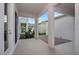 This patio features a light-colored flooring, a brick-paved area, and white pillars supporting the roof structure at 16465 Hamlin View St, Winter Garden, FL 34787