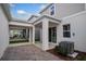 Covered patio with brick pavers, light-colored concrete, and modern design, enhancing outdoor living space at 16465 Hamlin View St, Winter Garden, FL 34787