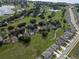 Beautiful aerial view of a residential neighborhood featuring mature trees, ponds, and well-maintained lawns at 16627 Rockwell Heights Ln, Clermont, FL 34711