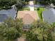 Aerial shot showcasing a home with a screened patio nestled among mature trees and well-maintained landscaping at 16627 Rockwell Heights Ln, Clermont, FL 34711