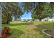 View of spacious backyard and the screened-in lanai at 16627 Rockwell Heights Ln, Clermont, FL 34711