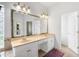 Bathroom featuring double sinks with a cream countertop and a large framed mirror at 16627 Rockwell Heights Ln, Clermont, FL 34711