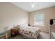 Bedroom featuring carpet, a ceiling fan, and a window at 16627 Rockwell Heights Ln, Clermont, FL 34711