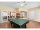 Spacious game room featuring hardwood floors and a colorful ceiling fan at 16627 Rockwell Heights Ln, Clermont, FL 34711