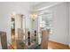 Bright dining room with a modern light fixture, large window, and tray ceiling at 16627 Rockwell Heights Ln, Clermont, FL 34711