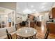 Open-concept dining area with hardwood floors and view of the kitchen and living room at 16627 Rockwell Heights Ln, Clermont, FL 34711