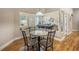 Well-lit dining room with hardwood floors and a view of the pool table at 16627 Rockwell Heights Ln, Clermont, FL 34711