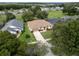 Aerial view of a single-story home boasts a meticulously kept lawn, mature trees, and proximity to the community at 16627 Rockwell Heights Ln, Clermont, FL 34711