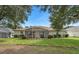 Back exterior of house with screen porch and backyard at 16627 Rockwell Heights Ln, Clermont, FL 34711