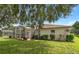 Back exterior of house with screen porch and backyard at 16627 Rockwell Heights Ln, Clermont, FL 34711