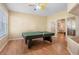 Bright game room featuring a ping pong table, wood floors, and a unique multi-colored ceiling fan at 16627 Rockwell Heights Ln, Clermont, FL 34711