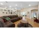 Cozy living room with light-colored walls, wood floors, and a comfortable sofa with decorative pillows at 16627 Rockwell Heights Ln, Clermont, FL 34711