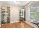 Comfortable living room with hardwood floors, natural light, and decorative display cabinets at 16627 Rockwell Heights Ln, Clermont, FL 34711