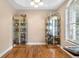 Comfortable living room with hardwood floors, natural light, and decorative display cabinets at 16627 Rockwell Heights Ln, Clermont, FL 34711