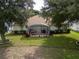 Inviting screened-in patio featuring a cozy seating area, ideal for relaxing and enjoying the outdoors at 16627 Rockwell Heights Ln, Clermont, FL 34711