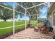 Screened-in porch with brick pavers offers backyard views, seating, and outdoor living space at 16627 Rockwell Heights Ln, Clermont, FL 34711