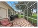 Screened-in porch with brick pavers offers an outdoor grilling and dining space at 16627 Rockwell Heights Ln, Clermont, FL 34711