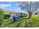 An expansive yard with mature trees and a set of outdoor chairs provide space to gather and play at 17764 Se 95Th Ct, Summerfield, FL 34491