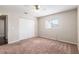 Neutral bedroom featuring closet, a window, a ceiling fan, and plush carpeting at 17764 Se 95Th Ct, Summerfield, FL 34491