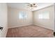 Neutral bedroom featuring two windows, a ceiling fan, and plush carpeting at 17764 Se 95Th Ct, Summerfield, FL 34491