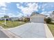 Street view of a single story home with an attached 2 car garage and beautiful newly poured concrete driveway at 17764 Se 95Th Ct, Summerfield, FL 34491