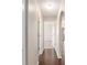 Inviting hallway featuring dark wood flooring, arched entryway, and neutral paint at 17764 Se 95Th Ct, Summerfield, FL 34491