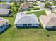 Aerial view of home showcasing a well-manicured lawn and proximity to other homes in the neighborhood at 17899 Se 115Th Cir, Summerfield, FL 34491