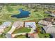 Stunning aerial shot of home highlighting landscaping, golf course views, and proximity to water at 17899 Se 115Th Cir, Summerfield, FL 34491