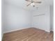 Neutral bedroom showcases wood-look flooring, ceiling fan, and closet for storage at 17899 Se 115Th Cir, Summerfield, FL 34491