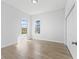 Spacious bedroom featuring light wood floors, closet, and two windows with natural light at 17899 Se 115Th Cir, Summerfield, FL 34491