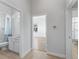 Bright hallway showing the tile floors and connecting doors to the bathroom and bedrooms at 17899 Se 115Th Cir, Summerfield, FL 34491