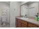 Bathroom featuring a well-lit vanity with a mirror and a separate toilet and shower area at 1817 Orange Ct, The Villages, FL 32162