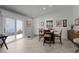 Dining area with table and chairs adjacent to sliding door providing light at 1817 Orange Ct, The Villages, FL 32162