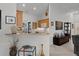 Open kitchen featuring a bar top, light wood cabinets, white appliances and bright lighting at 1817 Orange Ct, The Villages, FL 32162