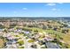 Wonderful aerial view of the property and surrounding homes set along the golf course in a lovely neighborhood at 1840 Madero Dr, The Villages, FL 32159