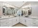 Beautiful bathroom with double sink vanity, stylish mirrors, quartz countertops, and modern fixtures at 1840 Madero Dr, The Villages, FL 32159