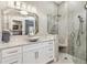 Beautiful bathroom with single sink vanity, stylish mirror, quartz countertops, and step-in shower at 1840 Madero Dr, The Villages, FL 32159