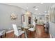 Dining room with hardwood floors, modern lighting, and glass table at 1840 Madero Dr, The Villages, FL 32159