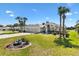 Inviting home with mature palm trees and a manicured front lawn and flower garden at 1840 Madero Dr, The Villages, FL 32159