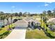 Beautiful home with a three-car garage and attractive landscaping, backing onto a lush golf course at 1840 Madero Dr, The Villages, FL 32159