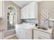 Bright laundry room with window, sink and cabinetry at 1840 Madero Dr, The Villages, FL 32159