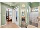 Hallway view of the main bathroom with a vanity and glass-enclosed shower at 1914 Antonia Pl, The Villages, FL 32159