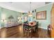 Dining room features hardwood floors, elegant chandelier, and ample seating for entertaining at 1914 Antonia Pl, The Villages, FL 32159