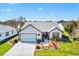 Charming single-story home featuring a well-manicured lawn and a brick-paved driveway at 1914 Antonia Pl, The Villages, FL 32159